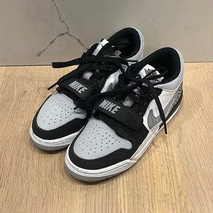 Grey, white, and black Nike Air Jordan lows.